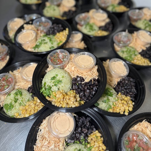 Chicken Burrito Bowl with shredded chicken, seasoned rice, black beans, roasted corn, pico de gallo, and chipotle Greek yogurt sauce