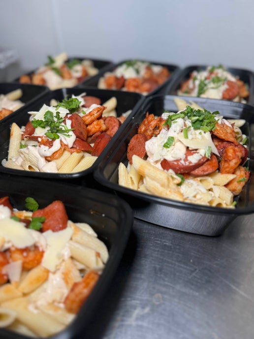 Cajun Pasta meal prep with penne, creamy Cajun sauce, grilled shrimp, and turkey sausage from Fresno meal plans