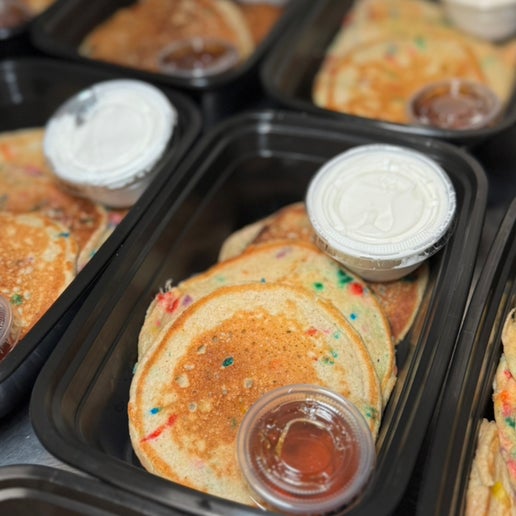 Birthday Cake protein pancakes topped with cool whip and sugar-free syrup from Fresno meal prep